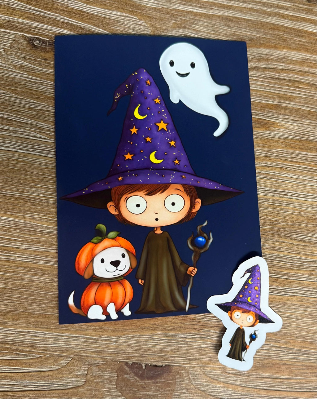 A witch wearing a purple hat with stars and a crescent moon, accompanied by a dog and a pumpkin, and a small ghost figure, all set against a dark blue background.