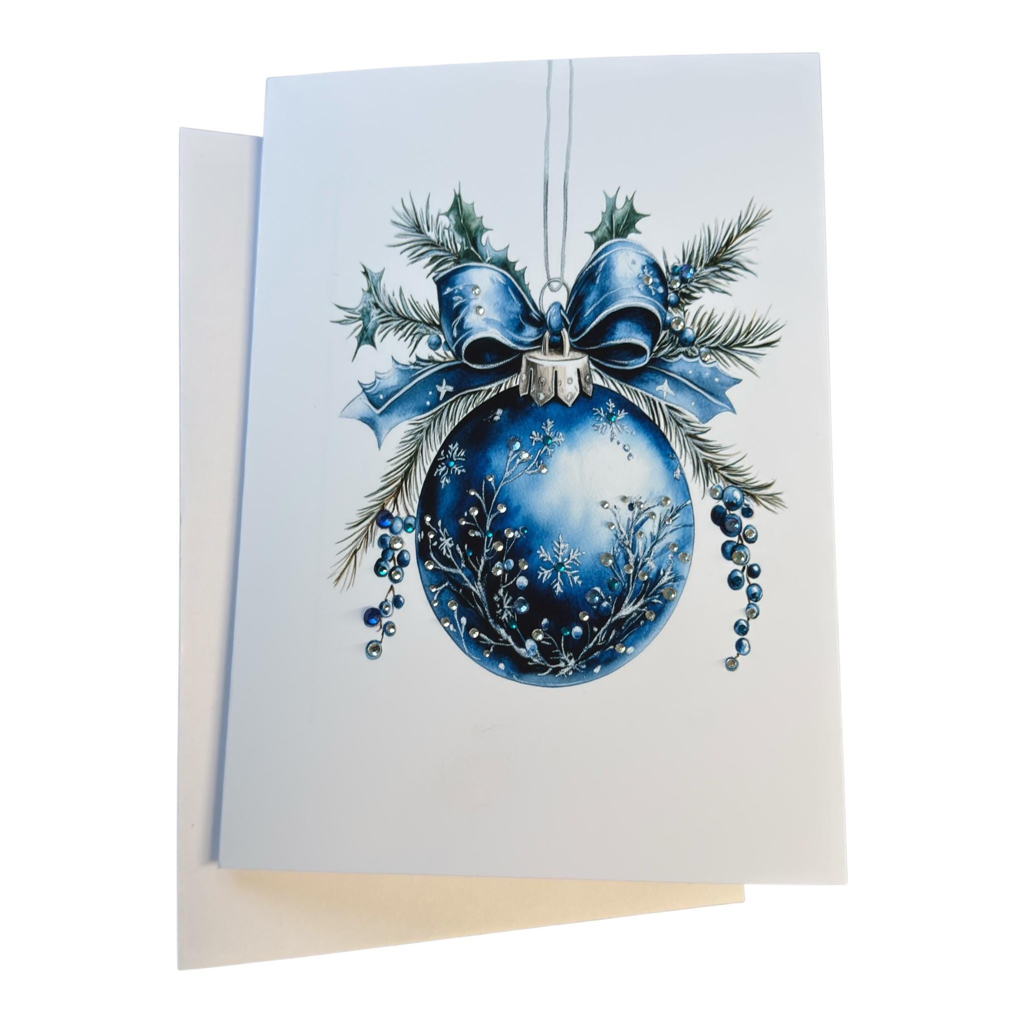 A blue Christmas ornament with a bow and pine branches is displayed on a white background.
