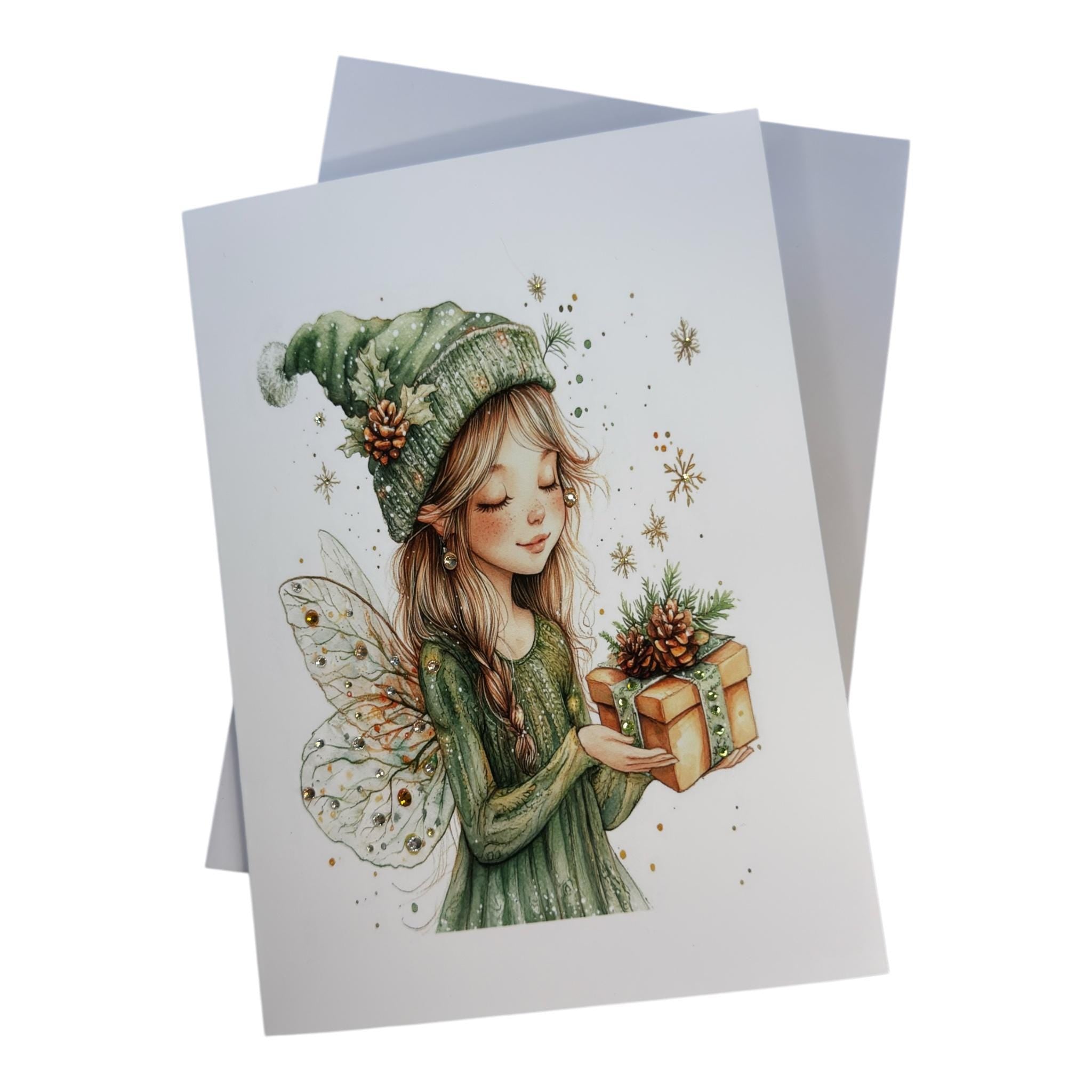 A fairy holding a gift box with wings and pine cones, surrounded by snowflakes.
