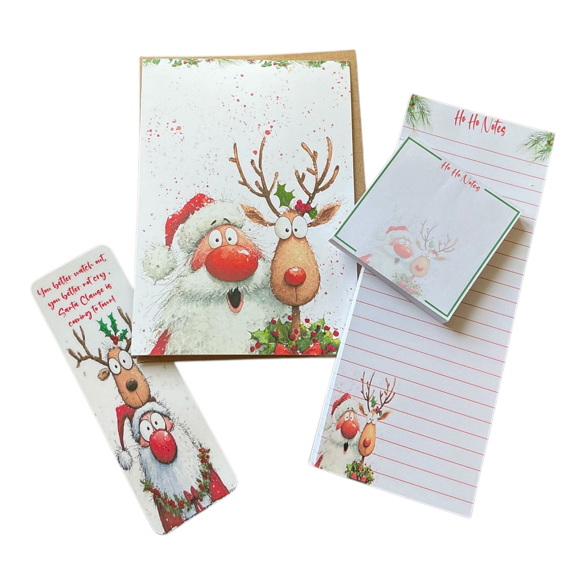 a collection of Christmas-themed items, including a greeting card, a notepad, and a bookmark. The greeting card features illustrations of Santa Claus and reindeer, while the notepad has a Christmas-themed design. The bookmark also has a Christmas-themed illustration.