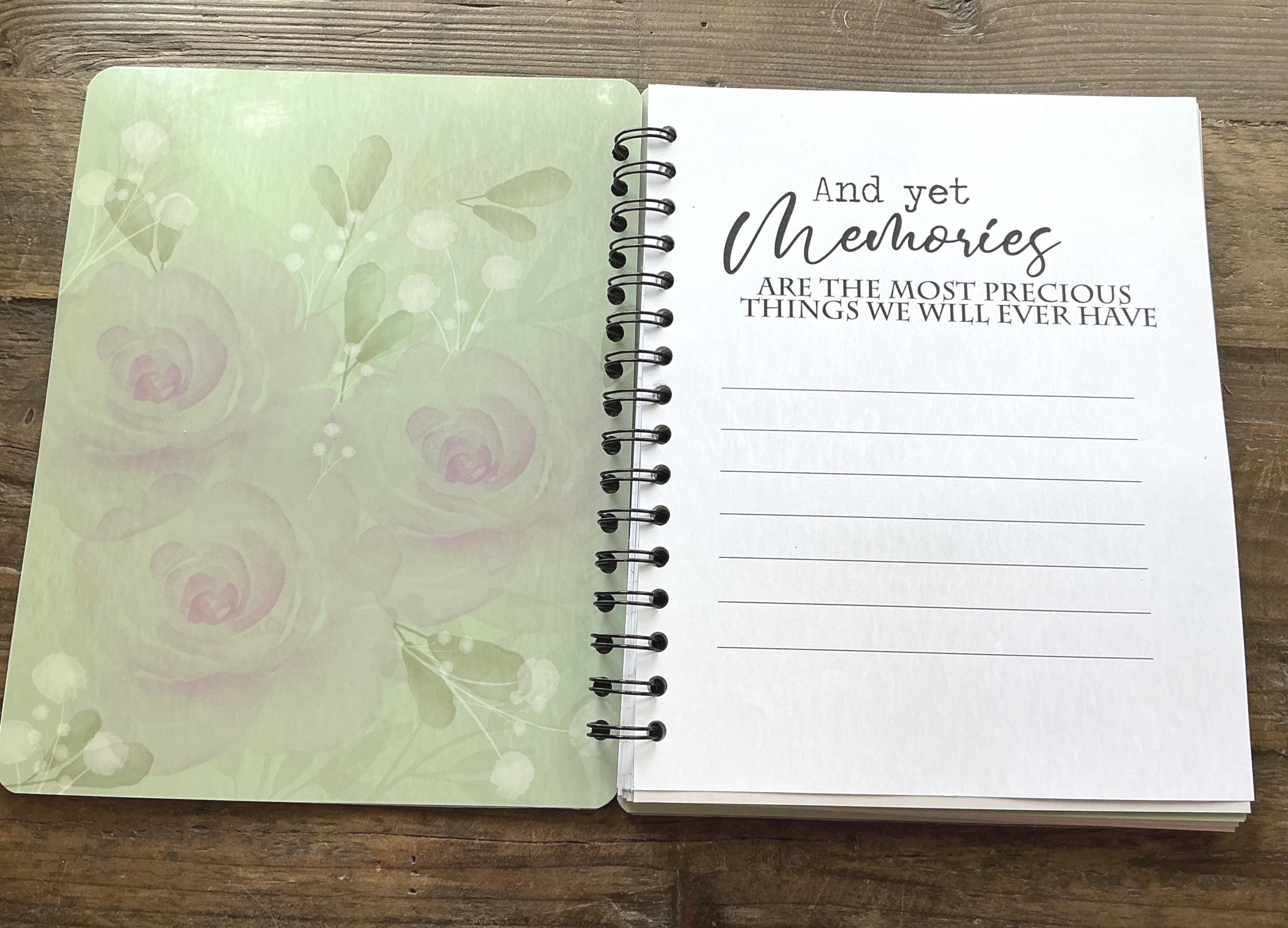 An open spiral-bound notebook with a floral design on the left page and a blank page on the right page, with a quote about memories written on the right page.