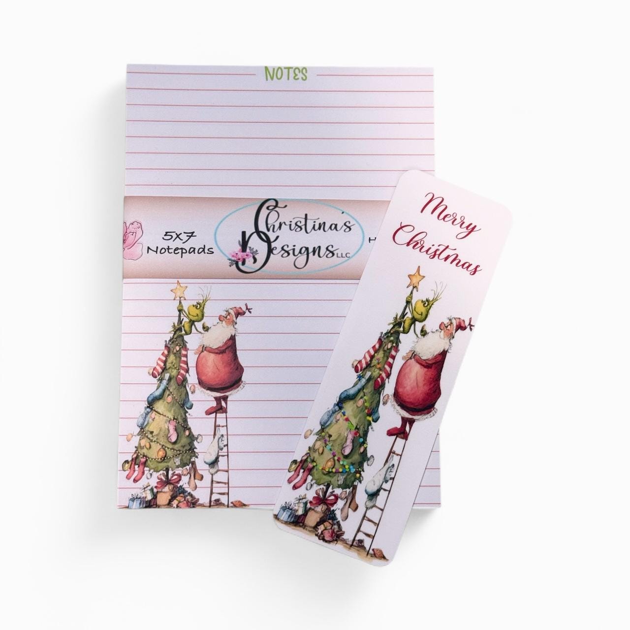 a set of Christmas-themed notepads and a bookmark with illustrations of Santa Claus and Christmas trees.