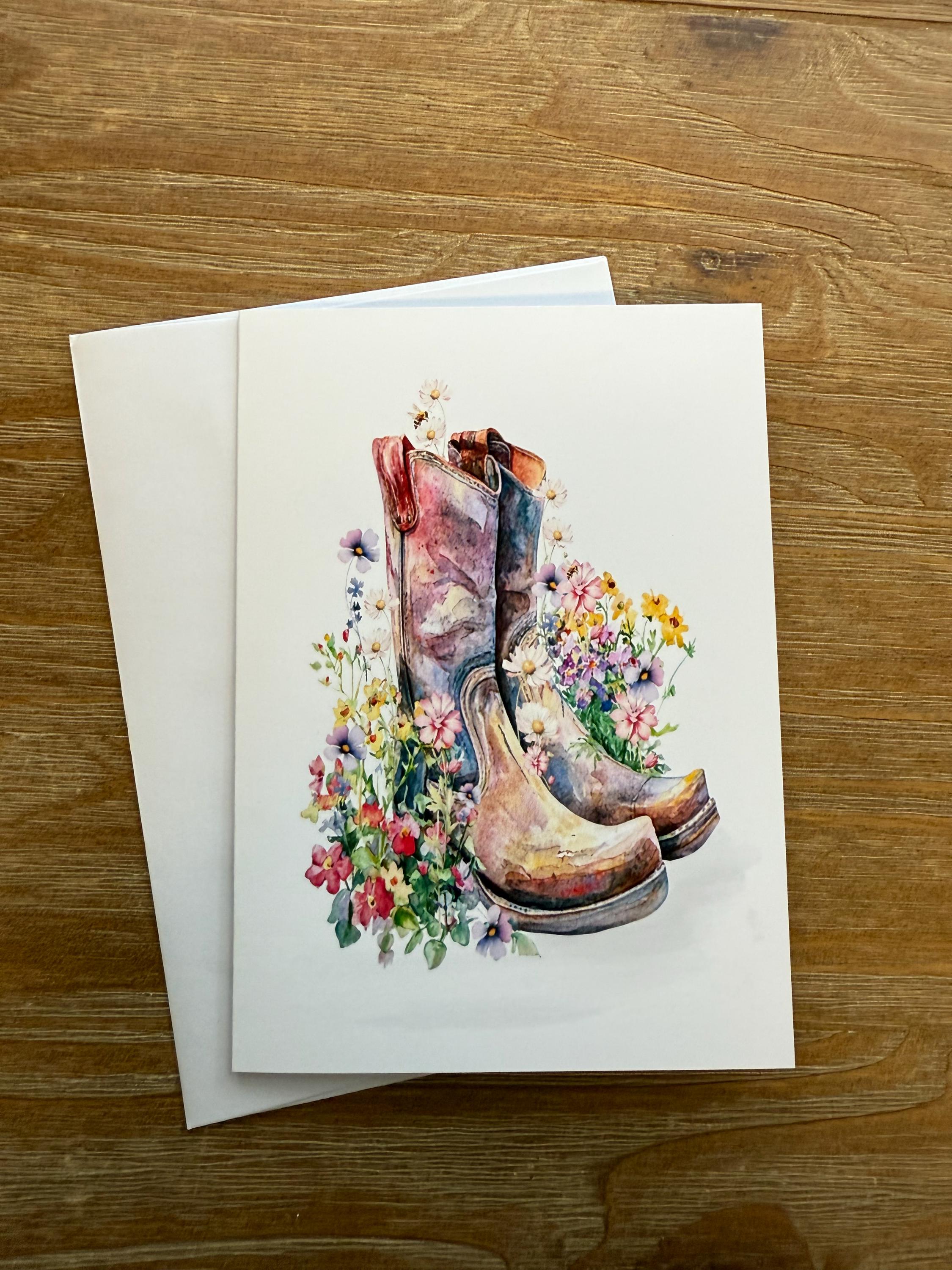 A pair of colorful, floral-patterned boots is depicted on a white card, surrounded by a vibrant arrangement of flowers.