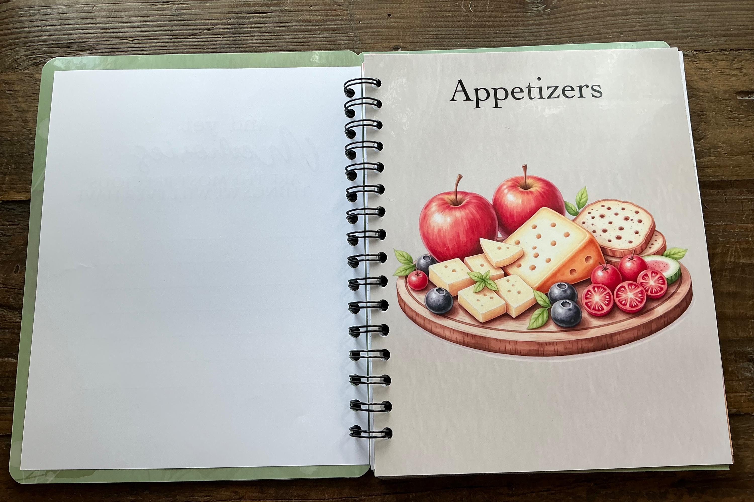 The image is an open spiral-bound notebook with a page featuring an illustration of various appetizers, including apples, cheese, and other food items.