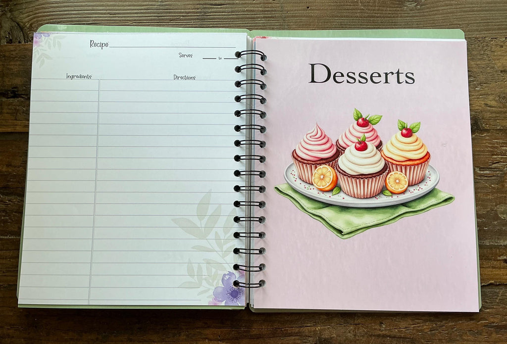 an open spiral-bound recipe book with a page for desserts and a blank page for a recipe.