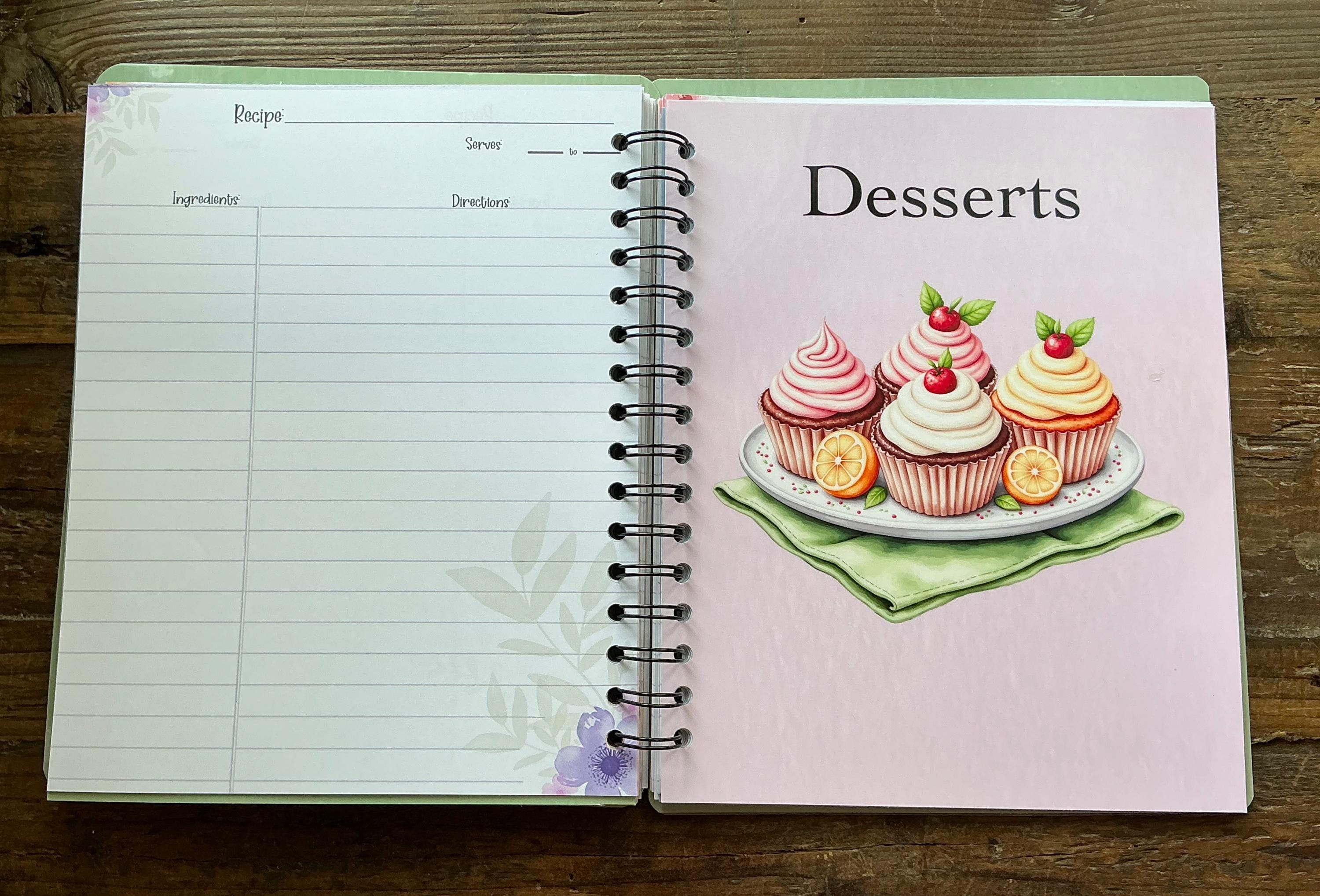 an open spiral-bound recipe book with a page for desserts and a blank page for a recipe.
