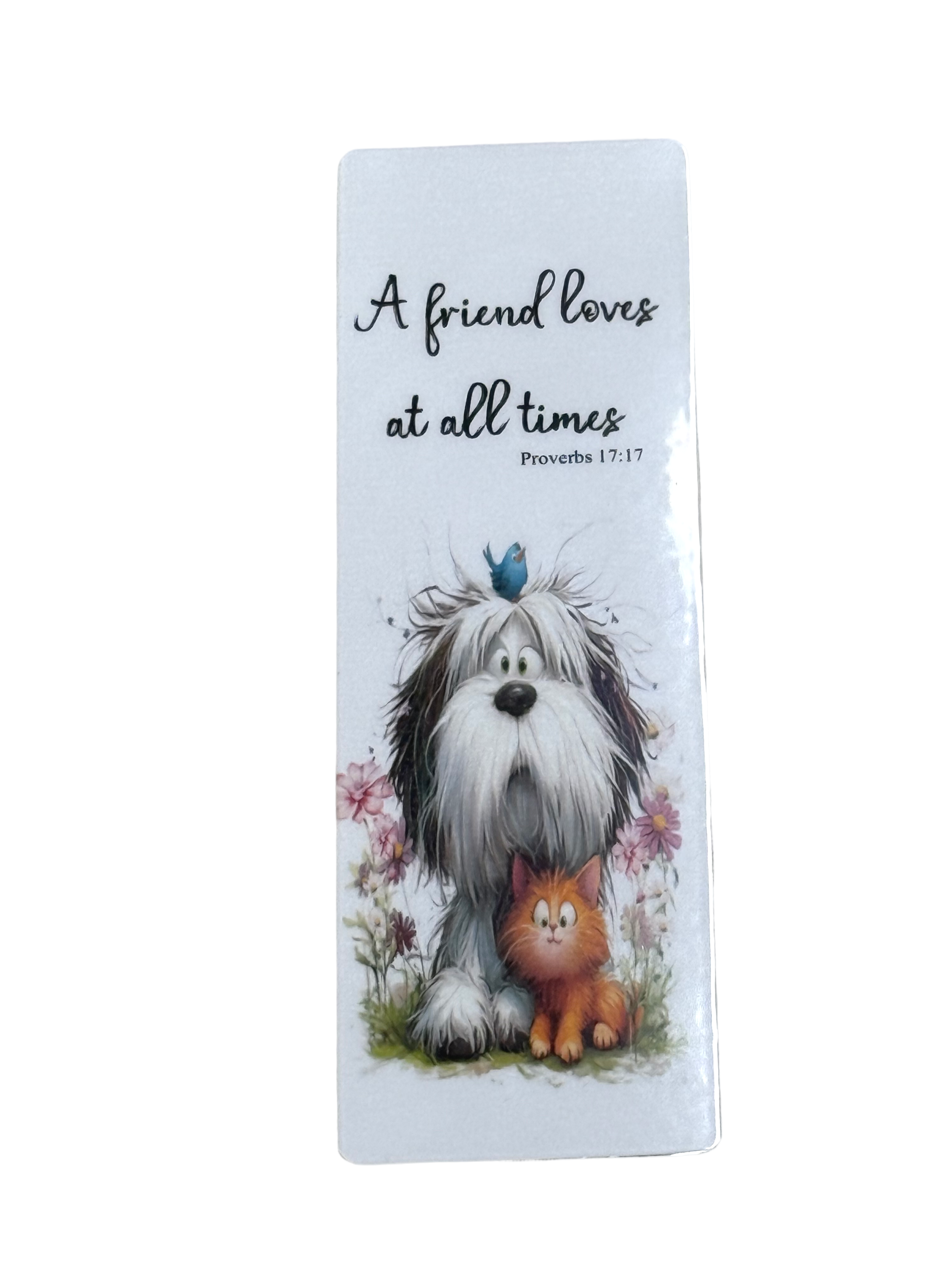 A white dog and a cat sitting together in a field with flowers, accompanied by a blue bird on its head.