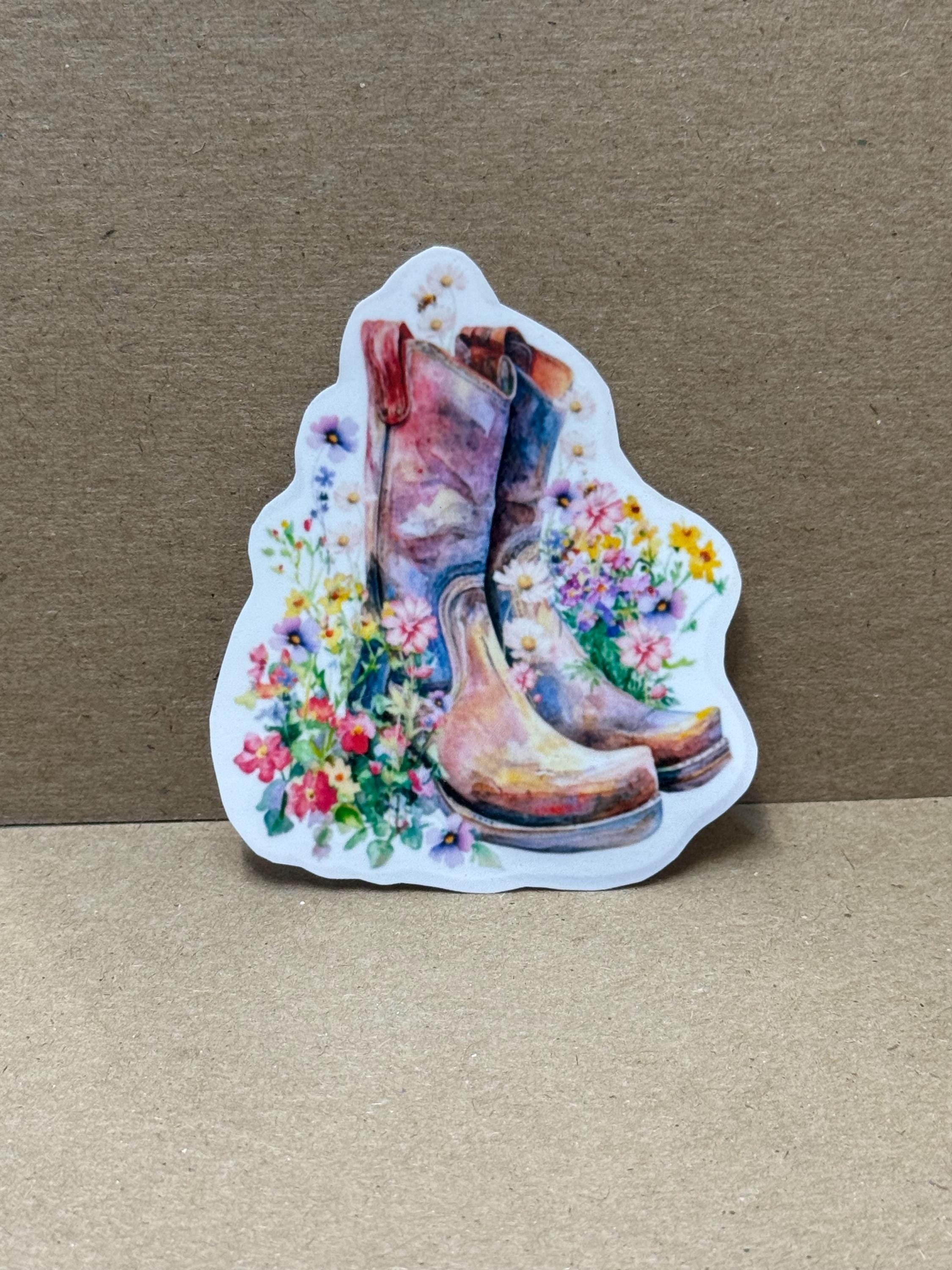 A sticker depicting a pair of colorful cowboy boots surrounded by a floral arrangement.