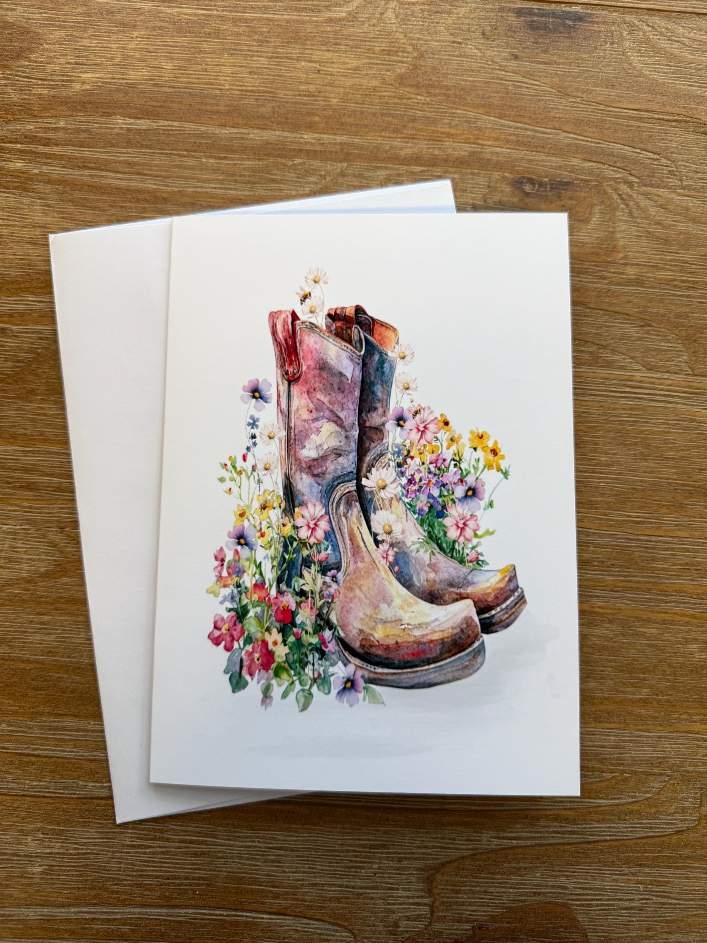 A pair of colorful, floral-patterned boots is depicted on a white background.