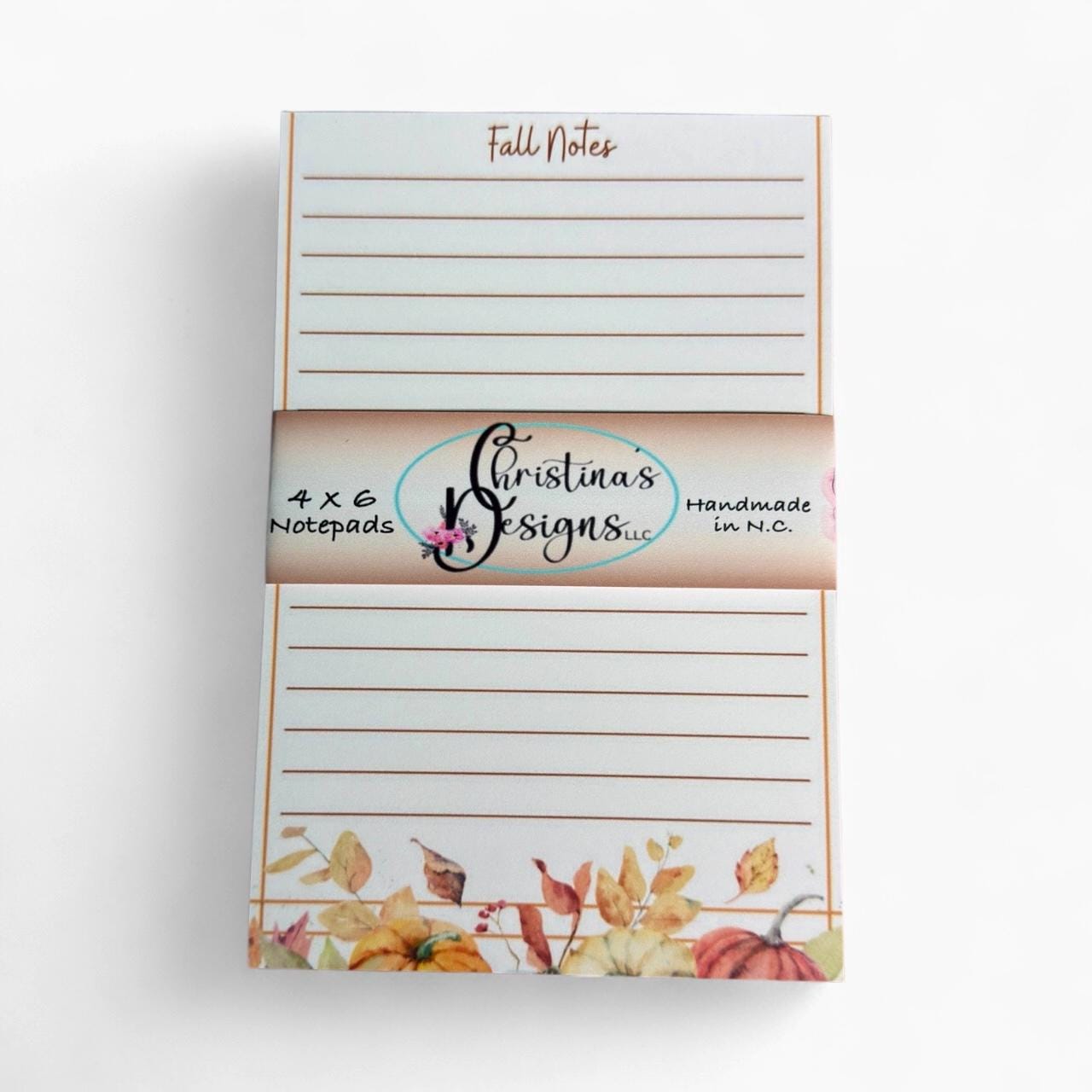 a set of lined notepads with a floral design on the cover.