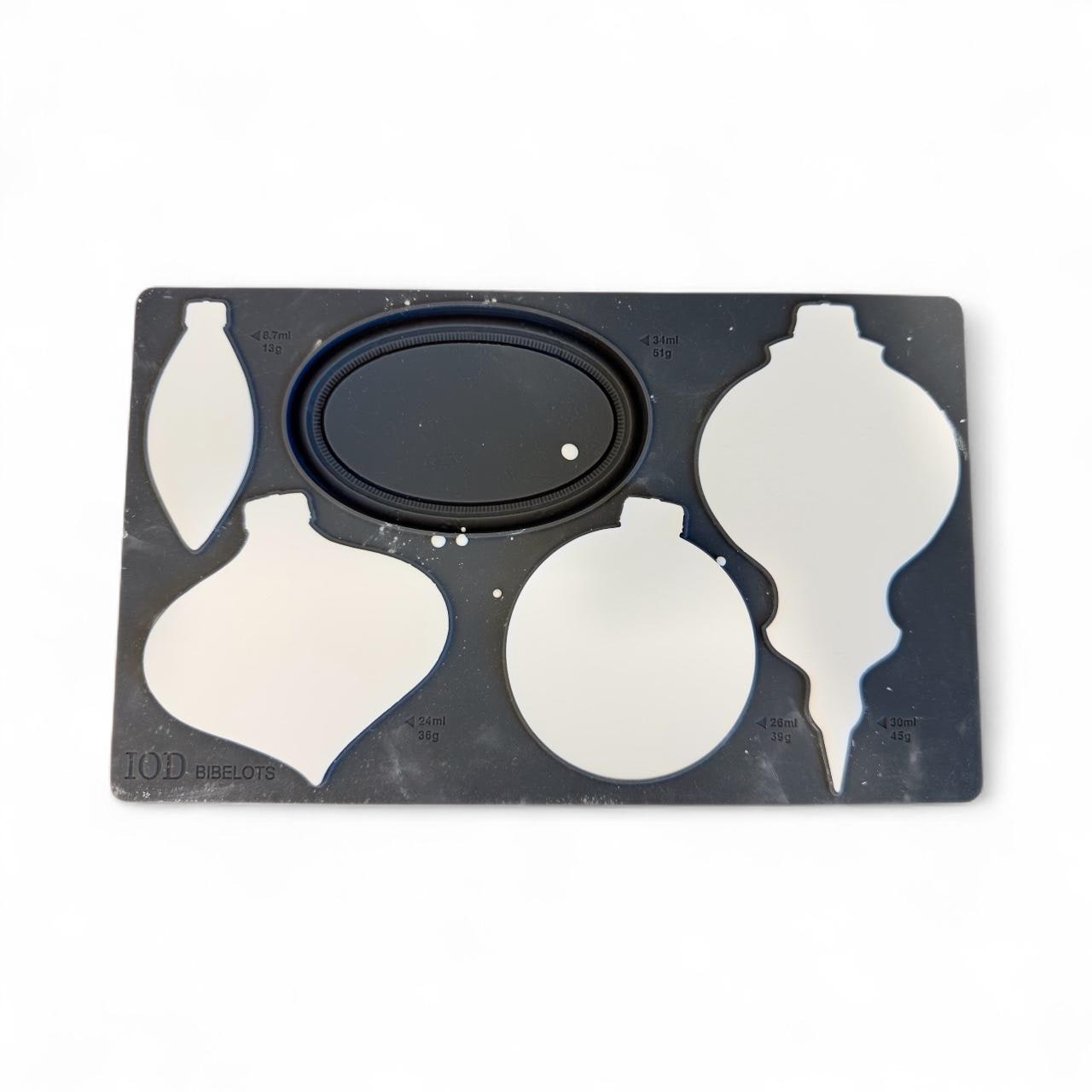 a black and white ornament mold with various ornament shapes, including a Christmas ornament, a bauble, and a bauble-shaped ornament.