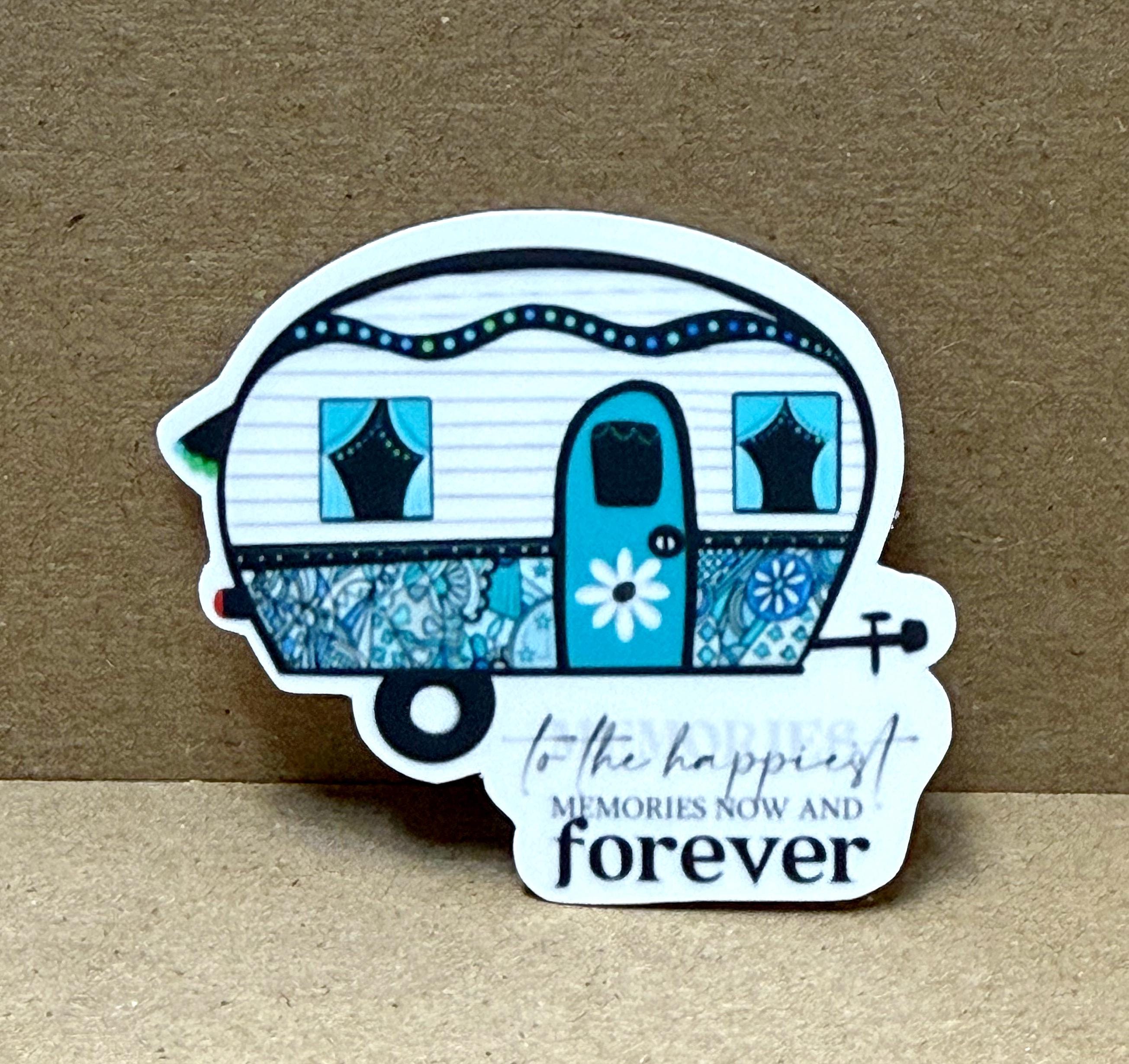 A sticker depicting a colorful, vintage-style camper trailer with a flower design on the door.