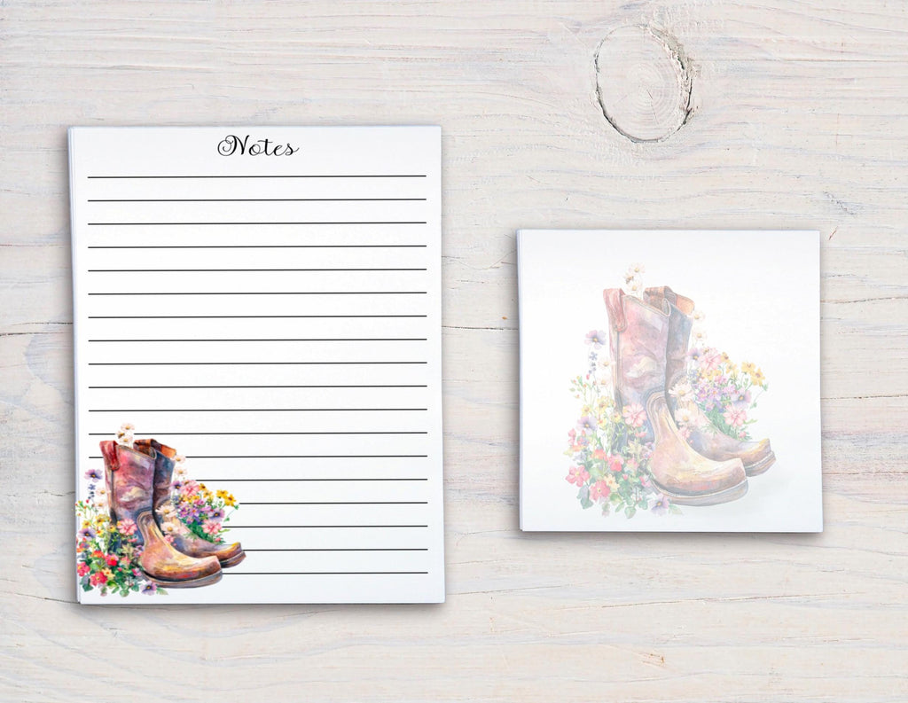 a pair of colorful, patterned boots on a white background, with a blank lined paper pad and a small square tile with a floral design.